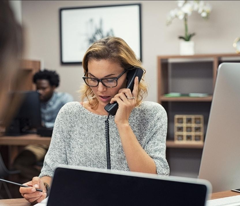 Woman speaking on the phone at an office desk