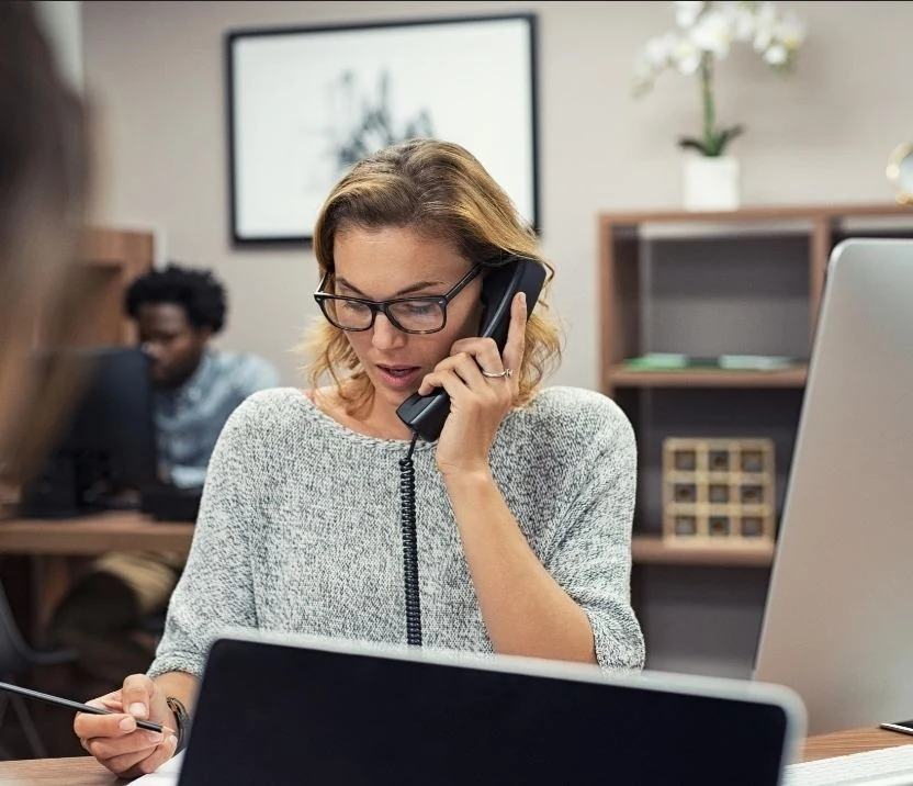 Woman speaking on the phone at an office desk